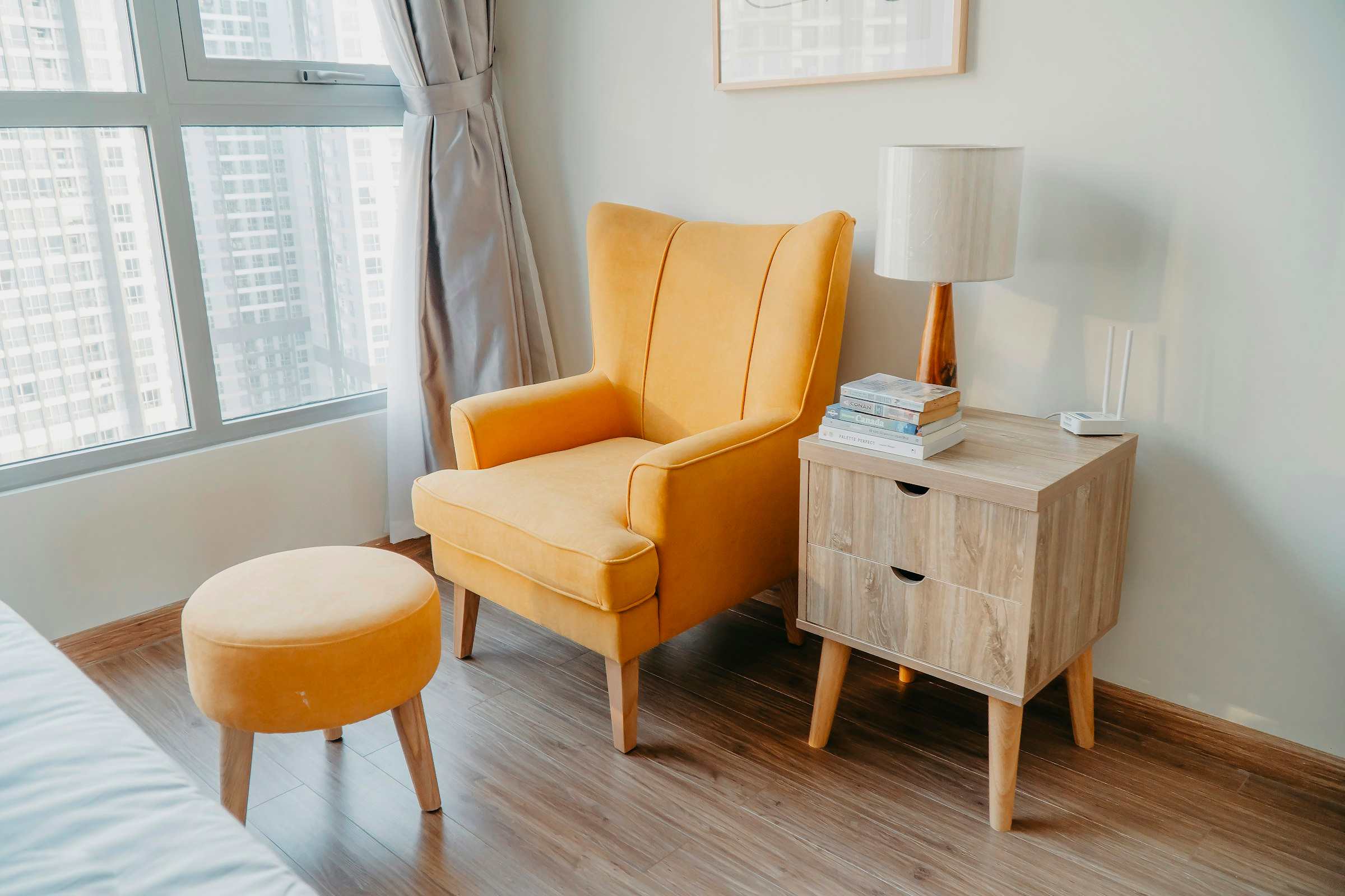 A finished bedroom with an assembled nightstand, armchair and bed