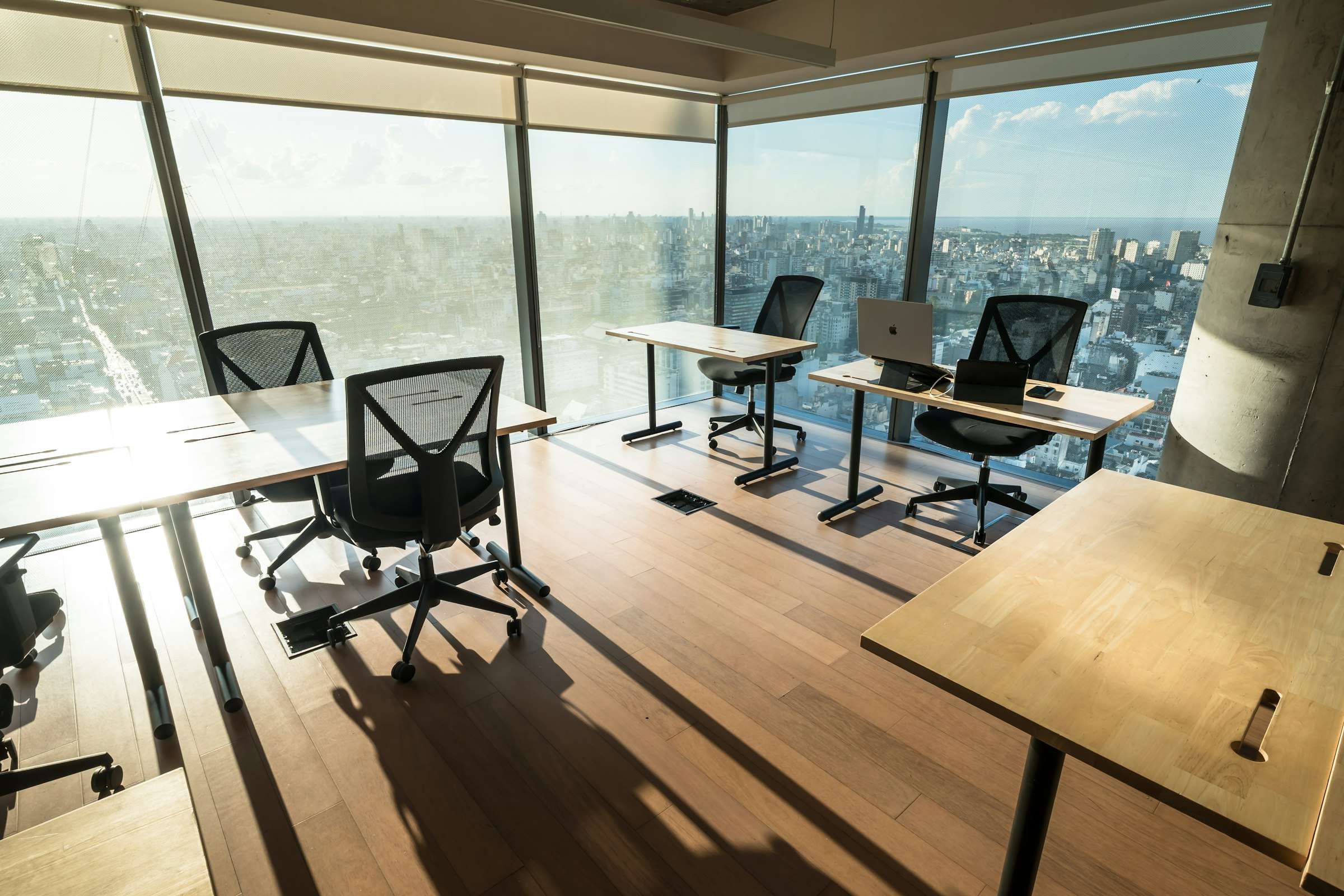 An open-plan office fitted out with rows of assembled desks and task chairs