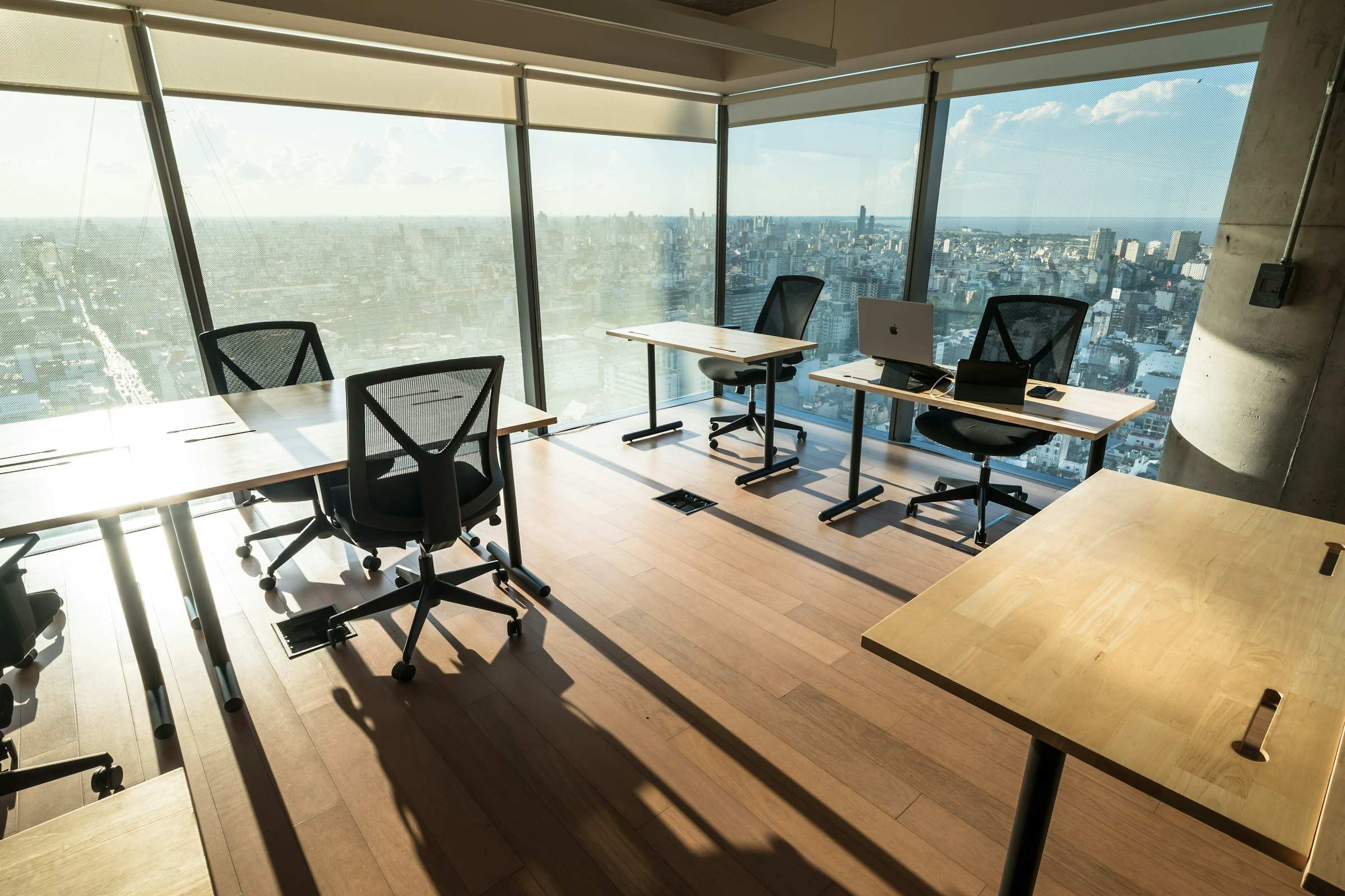 An open-plan office fitted out with rows of assembled desks and task chairs